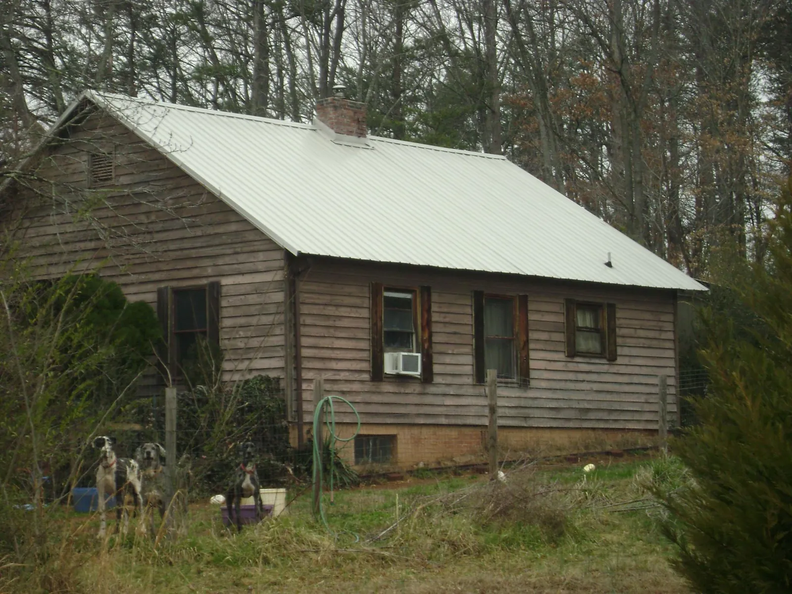 White metal roof on an old wood sided farmhouse, from a Metal Roof Installation job in Taylorsville